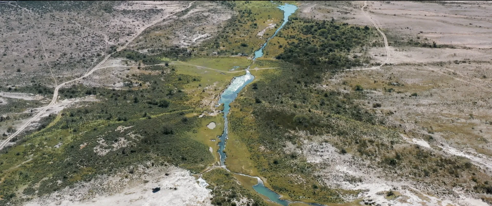 Aerial view of a river winding through a green valley